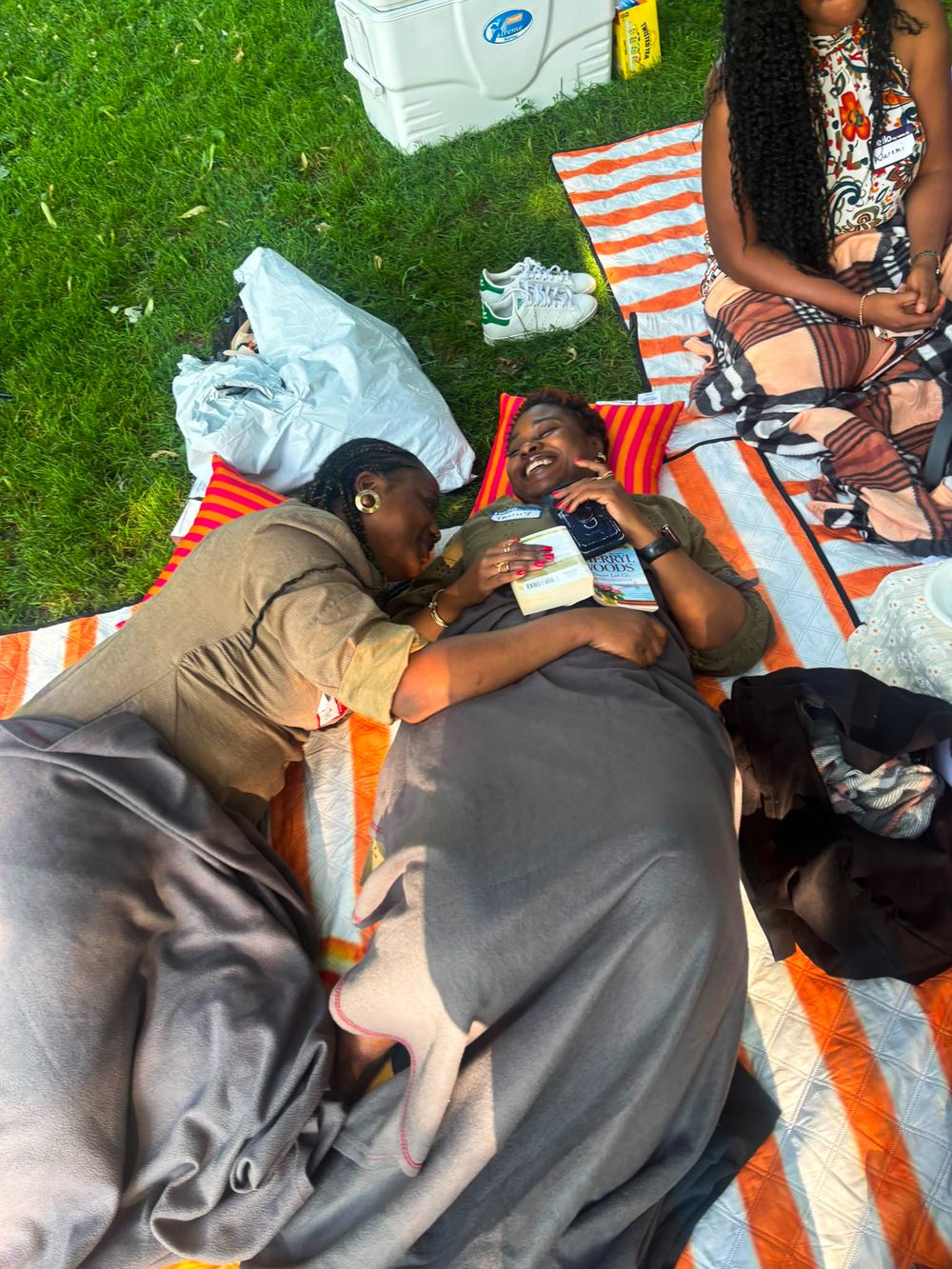 Pure joy — friends laughing together on the picnic blankets
